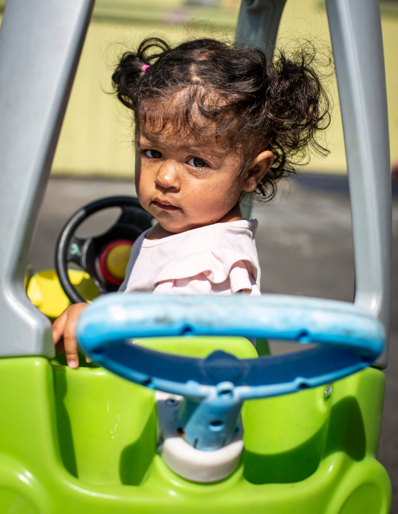 Child in toy car