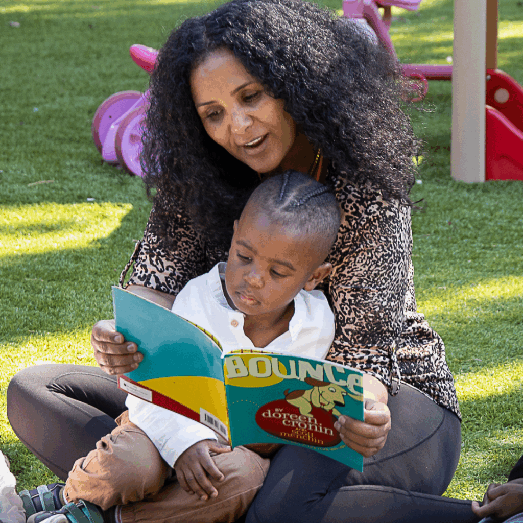 provider reads book with child
