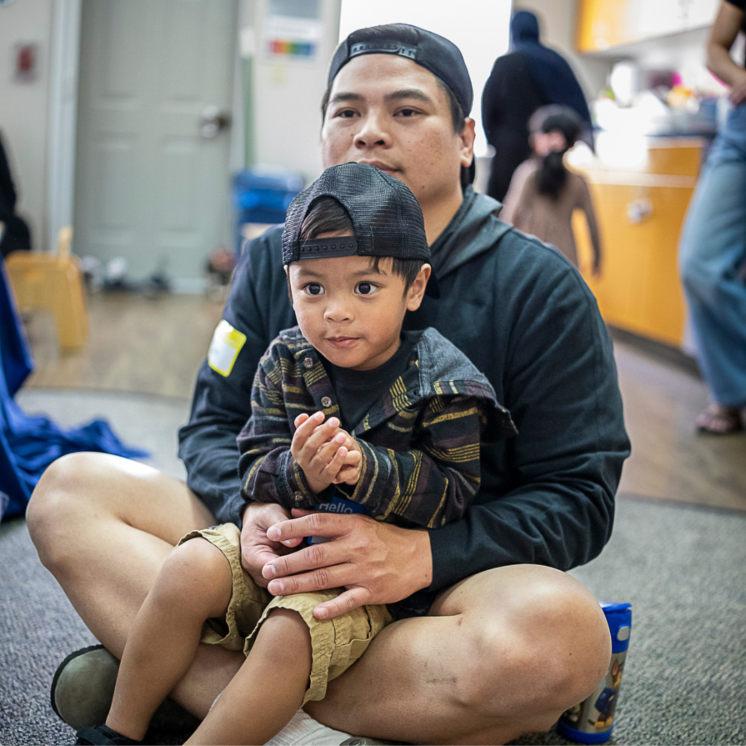 parent sits with child on lap