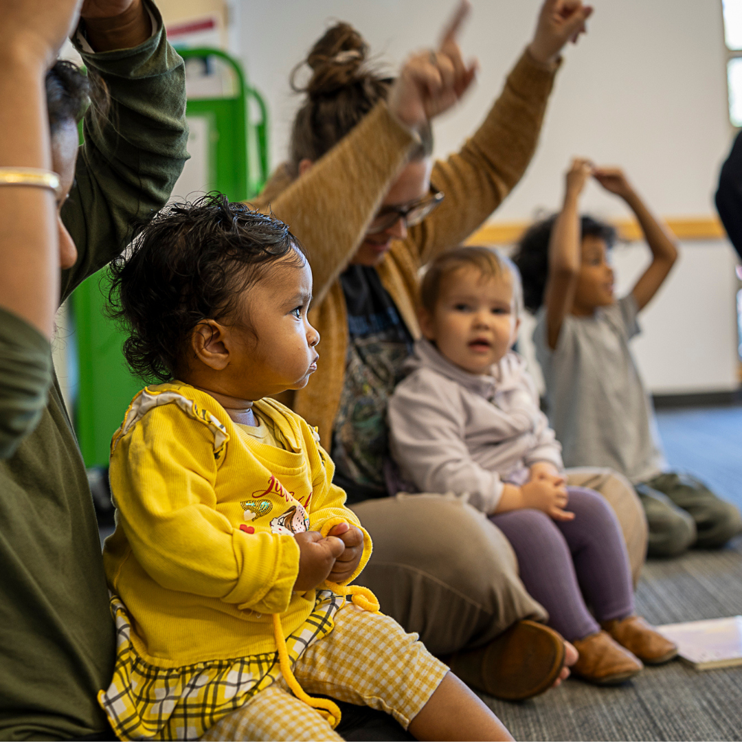 caregivers and children sing together