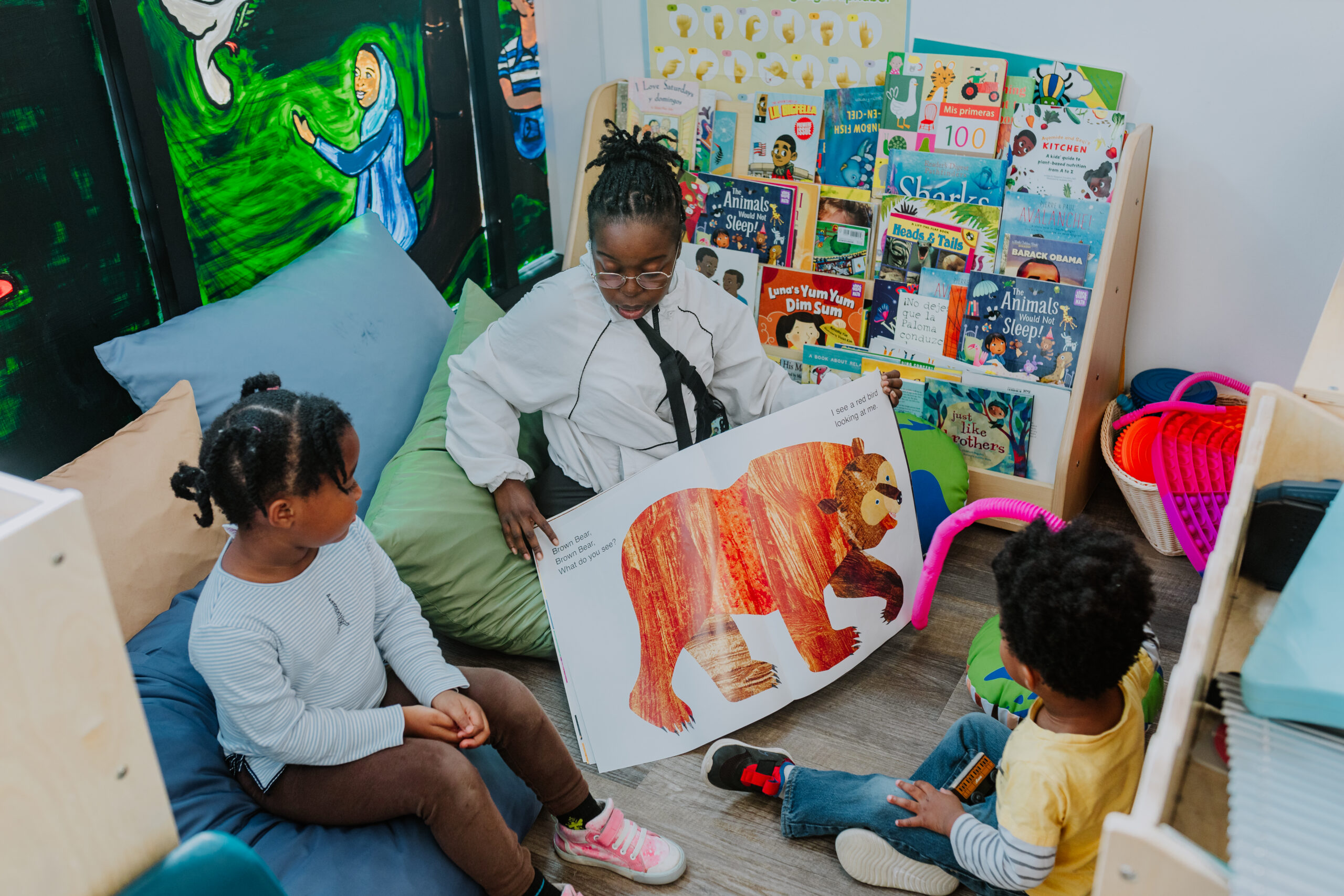 child care provider reads book with child
