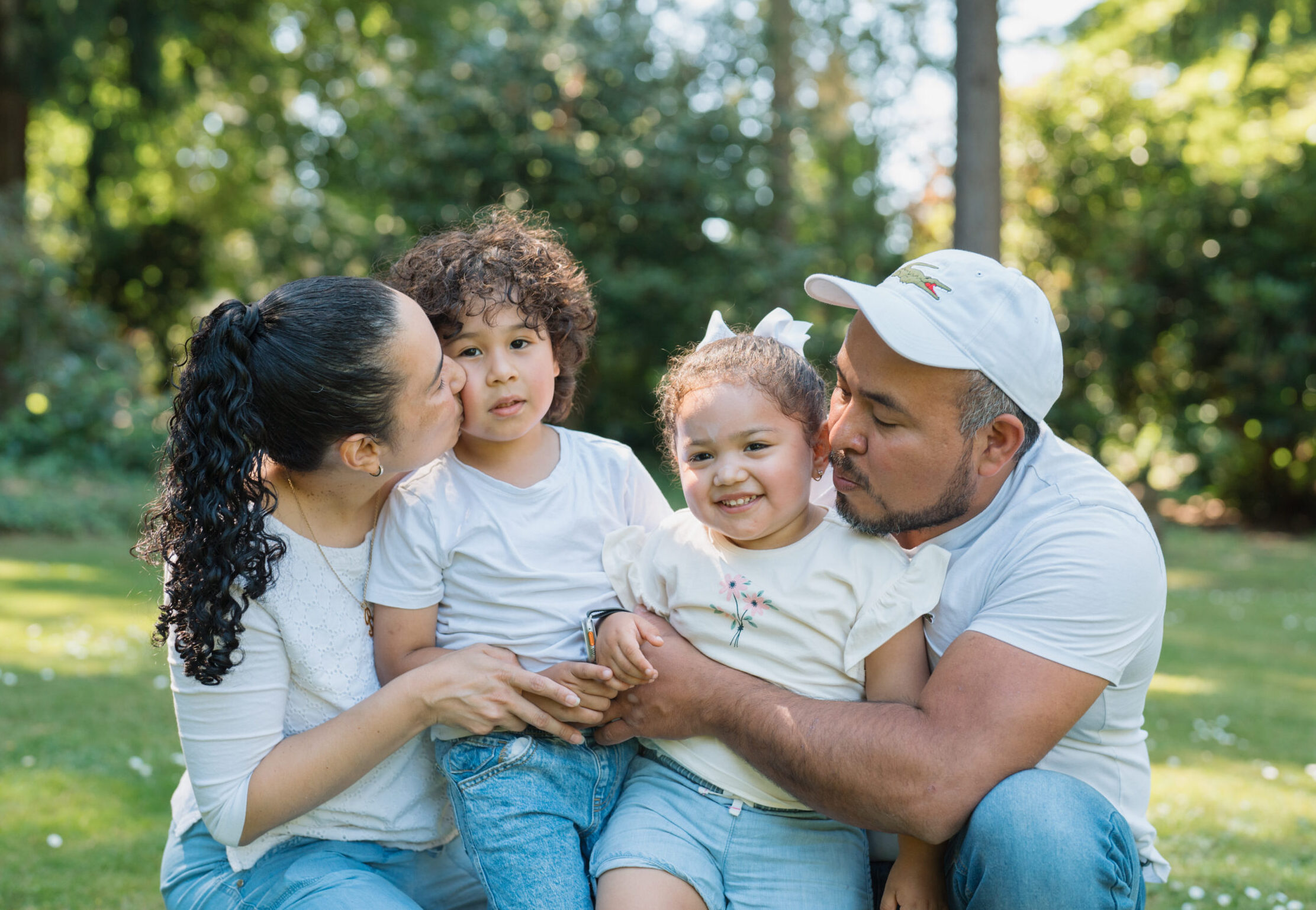 Mom, dad and two children outside